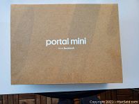 Closed kraft cardboard box labeled “portal mini from facebook”