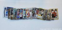 Photo showing a spread of 15 hockey sports cards with various players and designs, sleeves included.