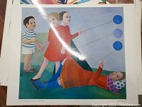 Top of the stack showing a high gloss print depicting children with blue balloons