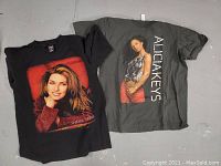 Black Shania Twain concert t-shirt with front print of the singer in a red sweater, medium size, tag shows PolyGram Merchandising brand