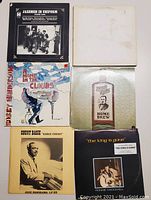 Top view of all six vintage jazz records arranged in two rows, showing cover art and titles including Jakemen in Uniform, Bobby Henderson's A Home in the Clouds and Home Brew, Count Basie, and Ronnie McDowell.