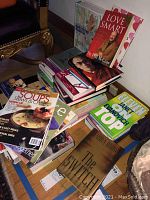 Photo showing several cooking books and magazines piled including Soup and Stew magazine, Best of Boston magazine and The Switch book