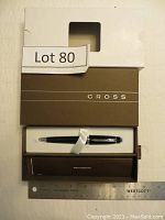 Cross ball point pen in original brown box with white protective sleeve visible in the packaging, including LOT 80 label and ruler for scale.