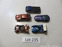 Top view of all five Hot Wheels cars in various colors arranged on tabletop