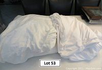 White flannel sheets and mattress cover arranged on a table showing softness and bulk