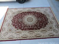 Full view of the machine made Persian style area rug laid out flat, showing overall design and size.
