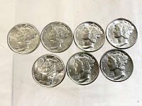 Front view of the seven Mercury dimes showing the obverse with Liberty's winged cap and dates 1935, 1936 (3 coins), and 1937 (3 coins).