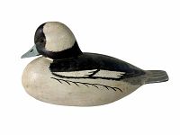 Left side profile view of the wooden bufflehead decoy showing overall shape and paint detail.
