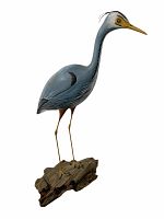 Full view of painted wooden heron decoy on driftwood base against white background