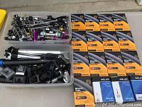 Overview showing two plastic bins with assorted bicycle parts and columns of Continental inner tube boxes.