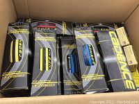 Cardboard box filled with multiple black and yellow Cadence Pulse inner tube boxes