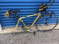 Full side view showing yellow frame, missing rear wheel