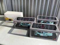 Four boxed resin model cars: three CMR 1:18 racing edition Porsche 917K Gulf livery and one Porsche Museum yellow model