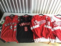 All four jerseys laid flat on table