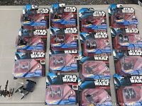 Hot Wheels Star Wars diecast vehicles in original sealed blue and black Star Wars packaging, arranged on a table, showing multiple TIE Fighter and X-Wing Fighter models.