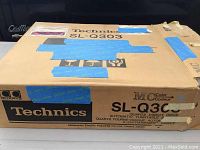 Cardboard shipping box labeled Technics SL-Q303 Quartz Direct Drive Automatic Turntable