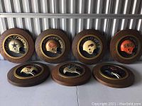 Seven plaques arranged in two rows on tabletop