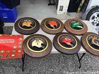 Six plaques laid out on table showing all team helmets