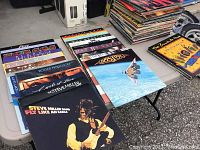 Wide view of multiple vinyl LPs laid out on folding table