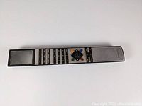Front view of Bang & Olufsen BEoRemote remote showing metallic button face and navigation controls.