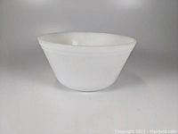 Side view of white vintage Federal Glass mixing bowl showing shape and rim