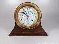 Front view of tide clock on wooden base