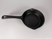 Top view of the 7-inch unmarked cast iron skillet showing the cooking surface and dual pouring spouts.