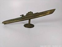 Side angle showcasing the elongated submarine shape and mounted base