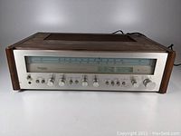 Front view of vintage Technics SA-5370 stereo receiver with wooden side panels and brushed aluminum front.