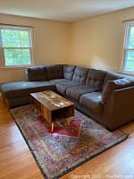 Full view of the brown fabric sectional sofa with corner chaise in living room, showing overall shape and size.