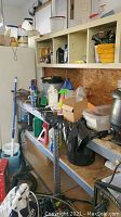 Garage shelving with assorted bottles of degreaser and cleaning supplies, bucket, mop and other items showing a typical workspace.