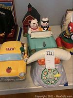 Overview showing all four ceramic jars: taxi, convertible car with cats, rotary phone and Flintstones house