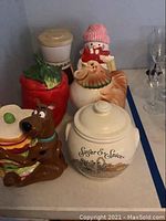 Photo showing Scooby-Doo cookie jar with sandwich, red pepper and rooster cookie jars, and 'Sugar & Spice' bean pot at front.