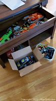 Photo showing several Nerf blasters in drawer with various foam darts and additional parts.