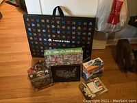 Photo showing all puzzles, puzzle storage mat/board, and framed metal artwork in a group.
