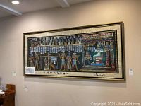 Full view of the framed papyrus painting on a wall