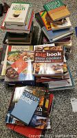 Stack of assorted hard and soft cover books on cooking, Irish themes, travel, history and Texas