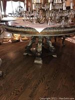 Full view of round marble-top table and carved wooden base