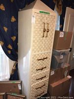 Front view of tall dresser with top cabinet doors and four drawers