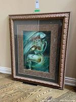 Full view of ornate wooden picture frame with glass, showing artwork inside for scale but not included in sale.