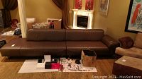 Wide front view of brown leather sectional sofa in living room