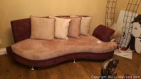 Front perspective of the curved two-tone sofa in room