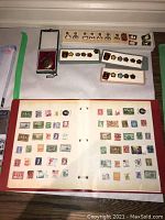 Overview showing stamp album, pin trays and pocket watch in box
