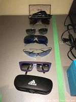 Overhead view of seven pairs of eyewear laid out in a line