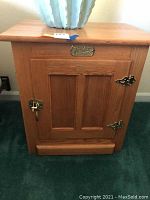 Front view of one oak White Clad nightstand with door closed.
