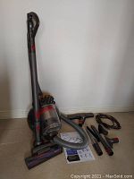 Overall view of vacuum, hose, heads, attachments and manual