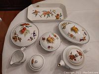 Full set of Royal Worcester Evesham serving pieces arranged on table, showing fruit pattern and shapes