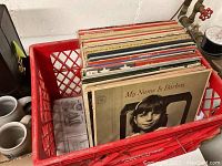 Red plastic crate filled with vinyl records including Barbra Streisand's 'My Name Is Barbra' album