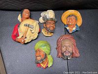 Five colorful chalkware wall plaques busts showing ethnic and character men in detailed painted design and vintage condition