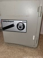 Front view of the Sentry Valueguard 1330 combination safe showing the dial lock and handle.